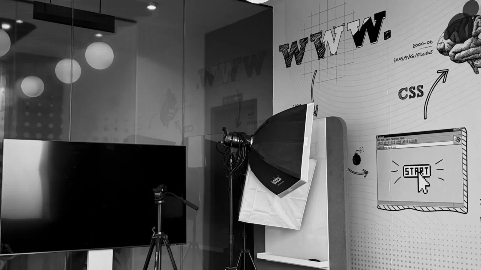 A studio wall showing web design sketches and a browser window drawing