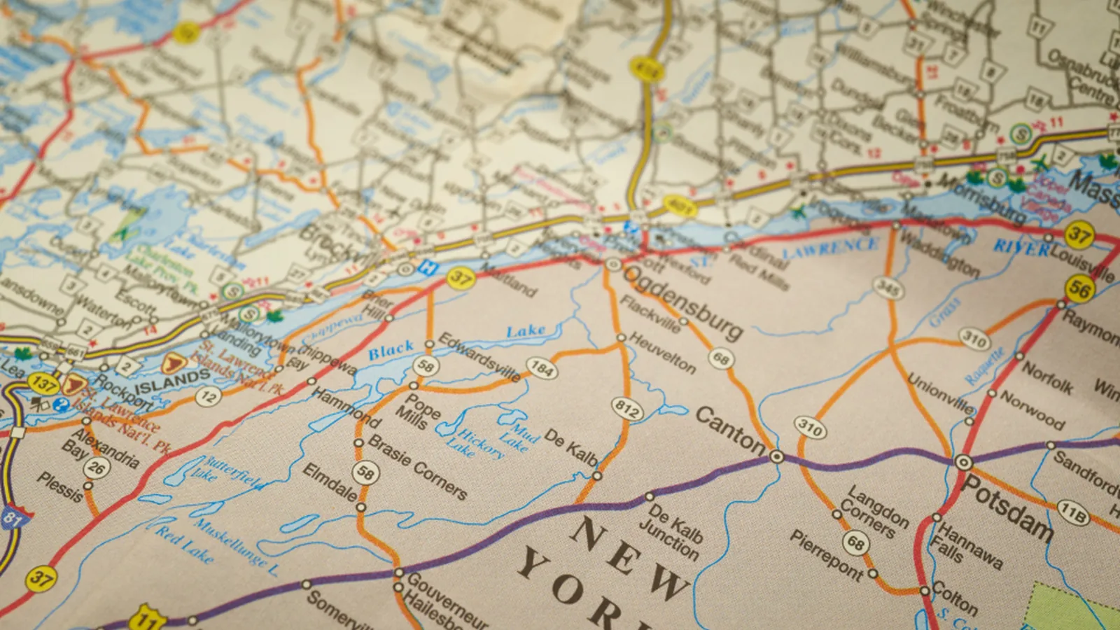 A close-up of a printed road map showing towns and routes