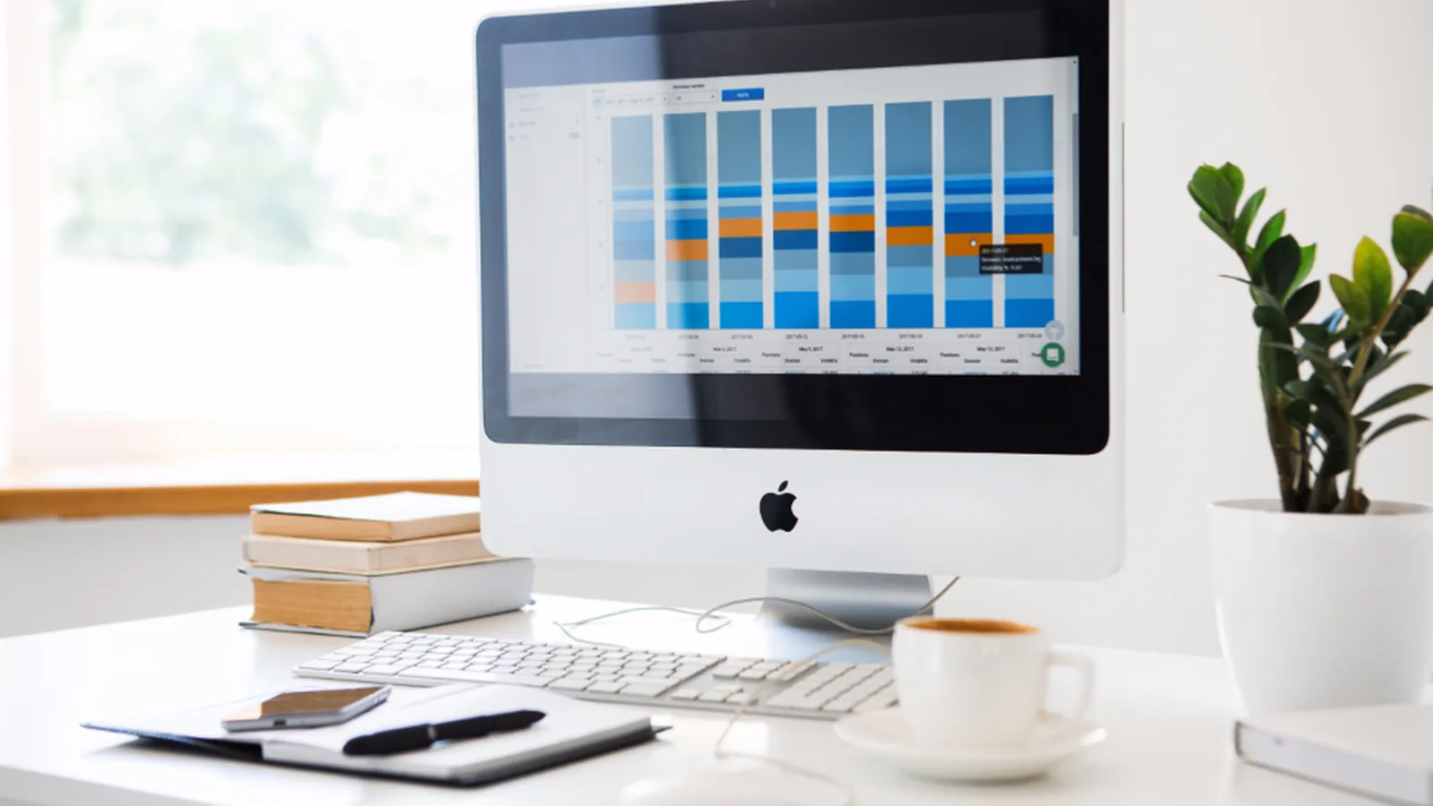 A desktop computer displaying a bar chart on a tidy office desk