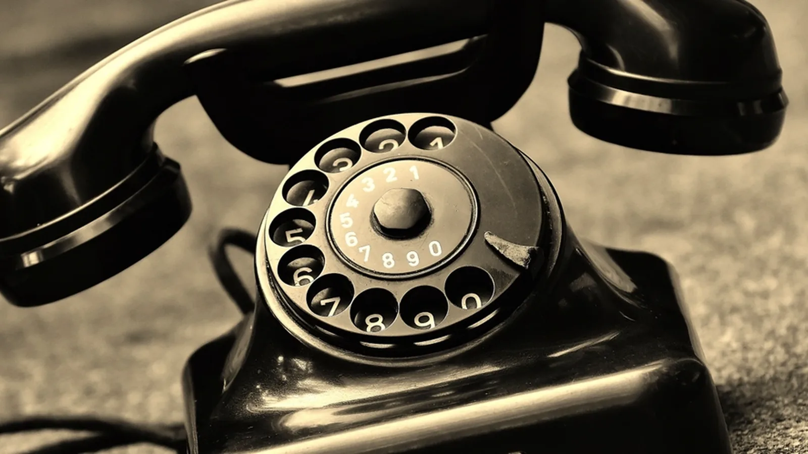 A vintage black rotary dial telephone